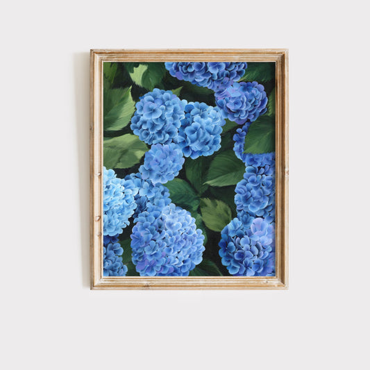 Framed artwork of blue flowers and green leaves on a white background