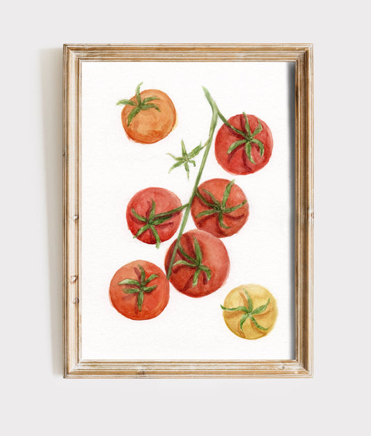 A framed watercolor art print depicting red and yellow tomatoes on a vine, set in a light wood frame against a neutral light background.