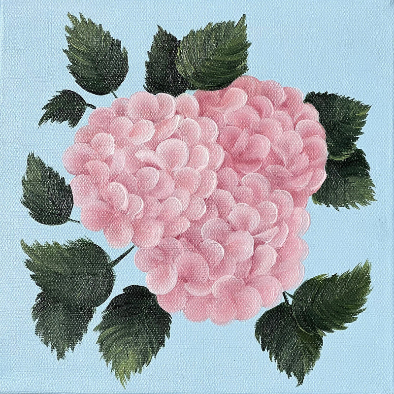 A square canvas painting featuring a pink hydrangea with green leaves on a light blue background, displayed on a textured beige linen surface.