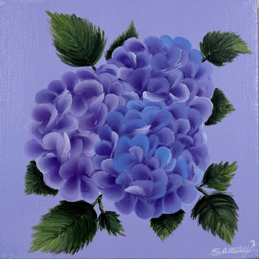 A small square canvas painting of purple and blue hydrangea flowers with green leaves on a lavender background, mounted on a textured beige wall.